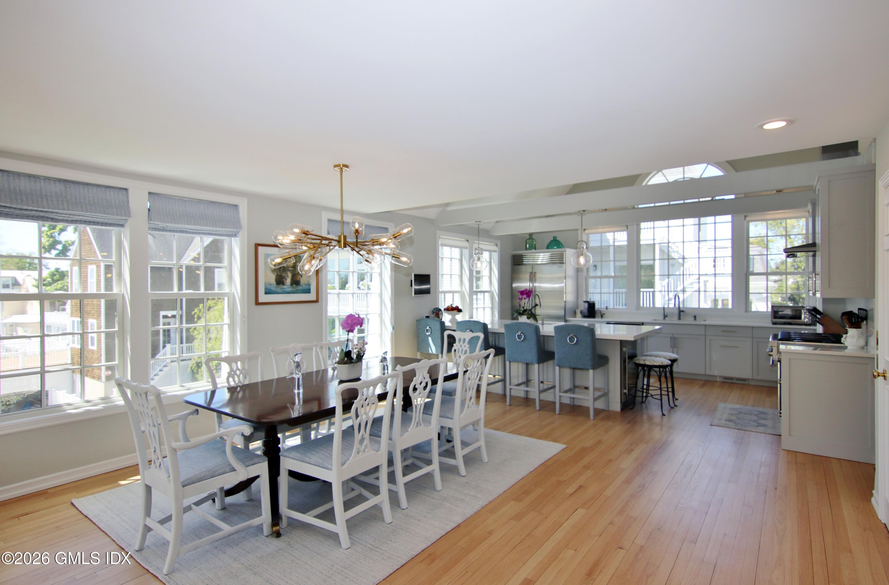 633 Steamboat Road, Unit 5 Greenwich, CT 06830 - Photo 15 of 29 a view of a dining room with furniture window and wooden floor