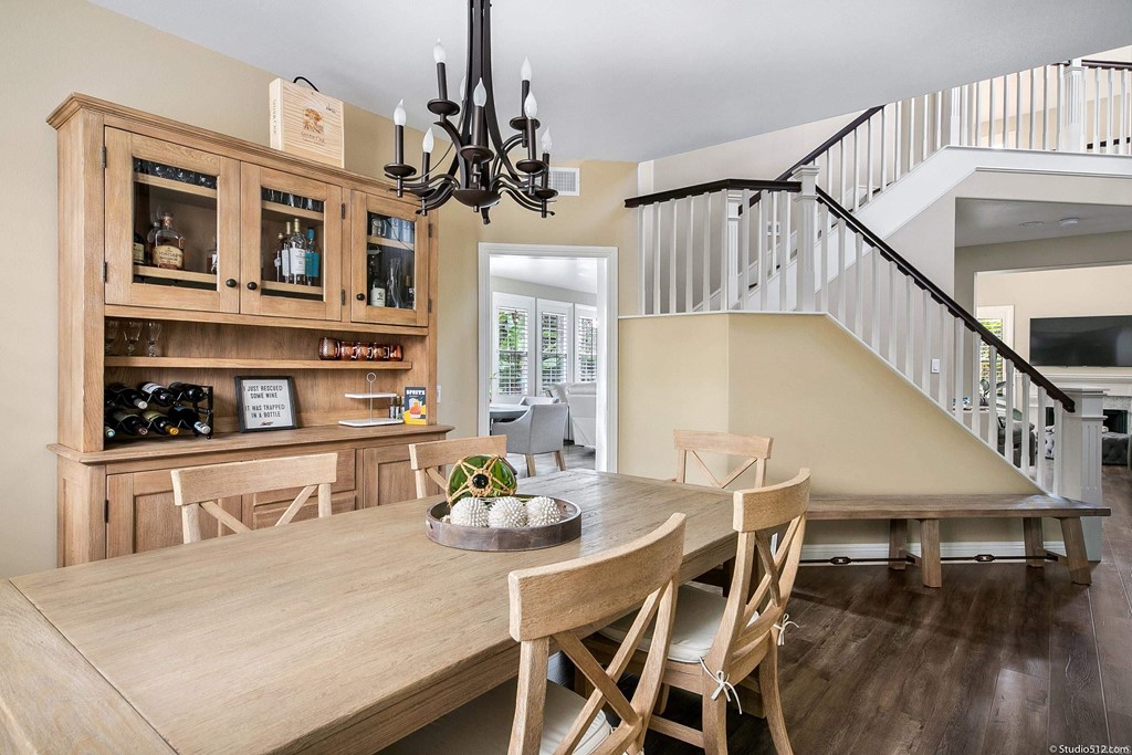 6425 Topmast Drive Carlsbad, CA 92011 - Photo 12 of 32 a view of a dining room with furniture a chandelier and wooden floor