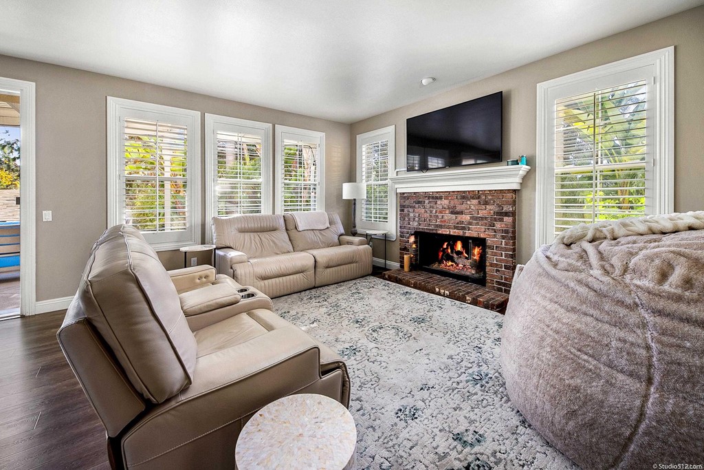 6425 Topmast Drive Carlsbad, CA 92011 - Photo 15 of 32 a living room with furniture a fireplace and a flat screen tv
