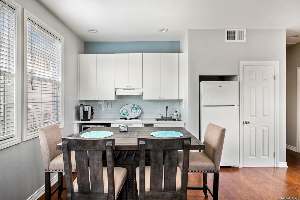 6425 Topmast Drive Carlsbad, CA 92011 - Photo 22 of 32 a view of a dining room with furniture and wooden floor