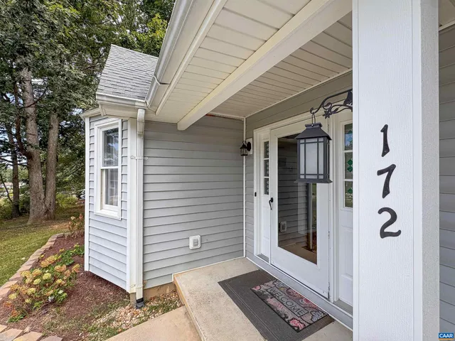 a large kitchen with stainless steel appliances a stove a sink dishwasher and a refrigerator with wooden floor