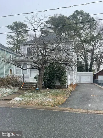 a view of a house with a snow in the yard