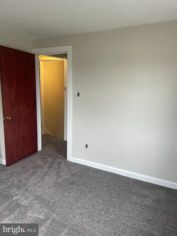 an empty room with closet area