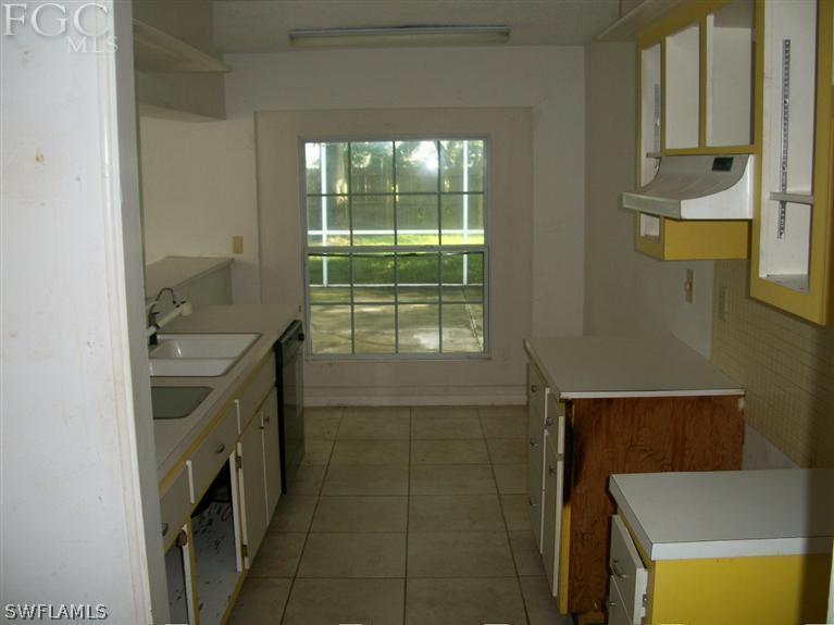 1802 Ridgecrest Street Lehigh Acres, FL 33936 - Photo 3 of 10 a bathroom with a sink a vanity and mirror