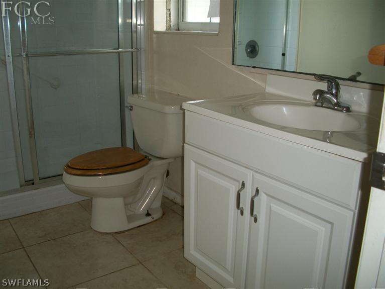 1802 Ridgecrest Street Lehigh Acres, FL 33936 - Photo 5 of 10 a bathroom with a toilet and a sink