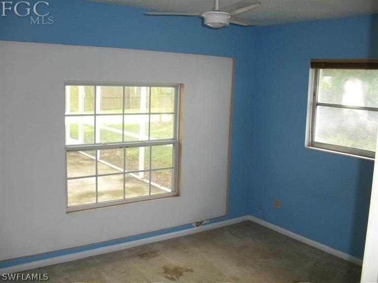 1802 Ridgecrest Street Lehigh Acres, FL 33936 - Photo 6 of 10 an empty room with a window