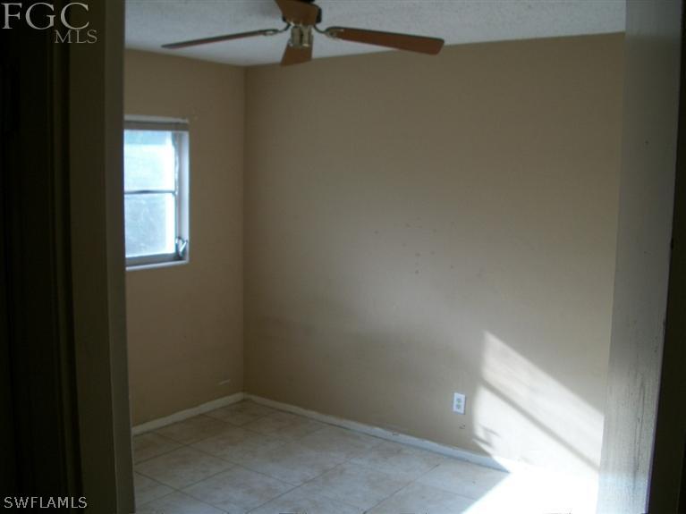 1802 Ridgecrest Street Lehigh Acres, FL 33936 - Photo 7 of 10 a view of a small space with wooden floor and a window