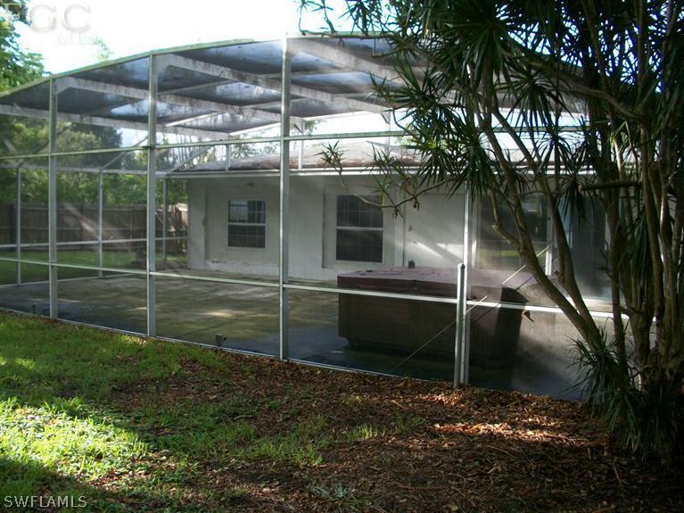 1802 Ridgecrest Street Lehigh Acres, FL 33936 - Photo 9 of 10 a backyard of a house with lots of green space