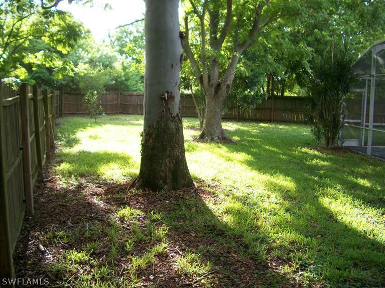 1802 Ridgecrest Street Lehigh Acres, FL 33936 - Photo 10 of 10 a backyard of a house with lots of green space