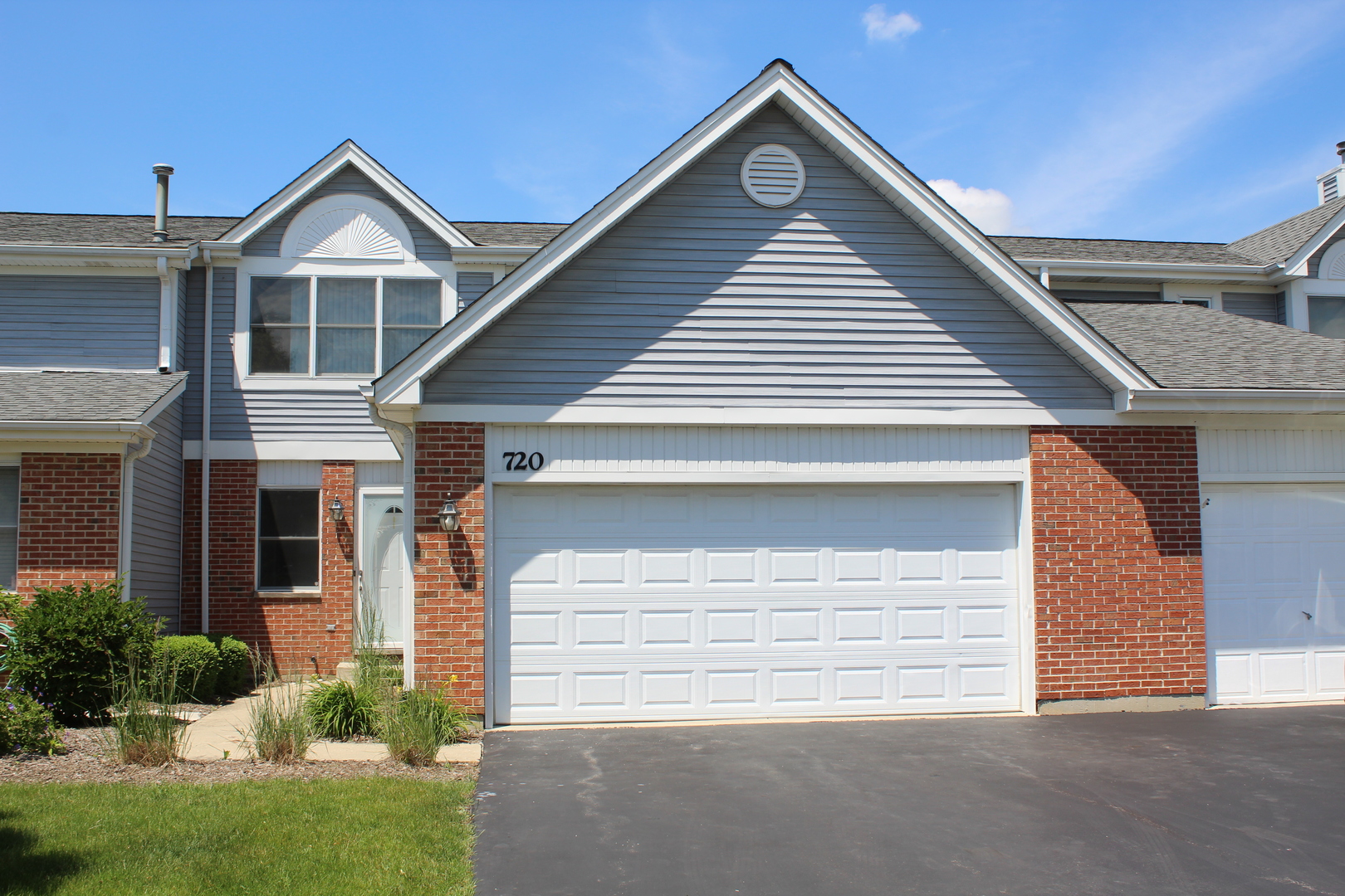 720 Daybreak Lane, Unit 720 Carol Stream, IL 60188 - Photo 1 of 22 a front view of a house with a yard and garage