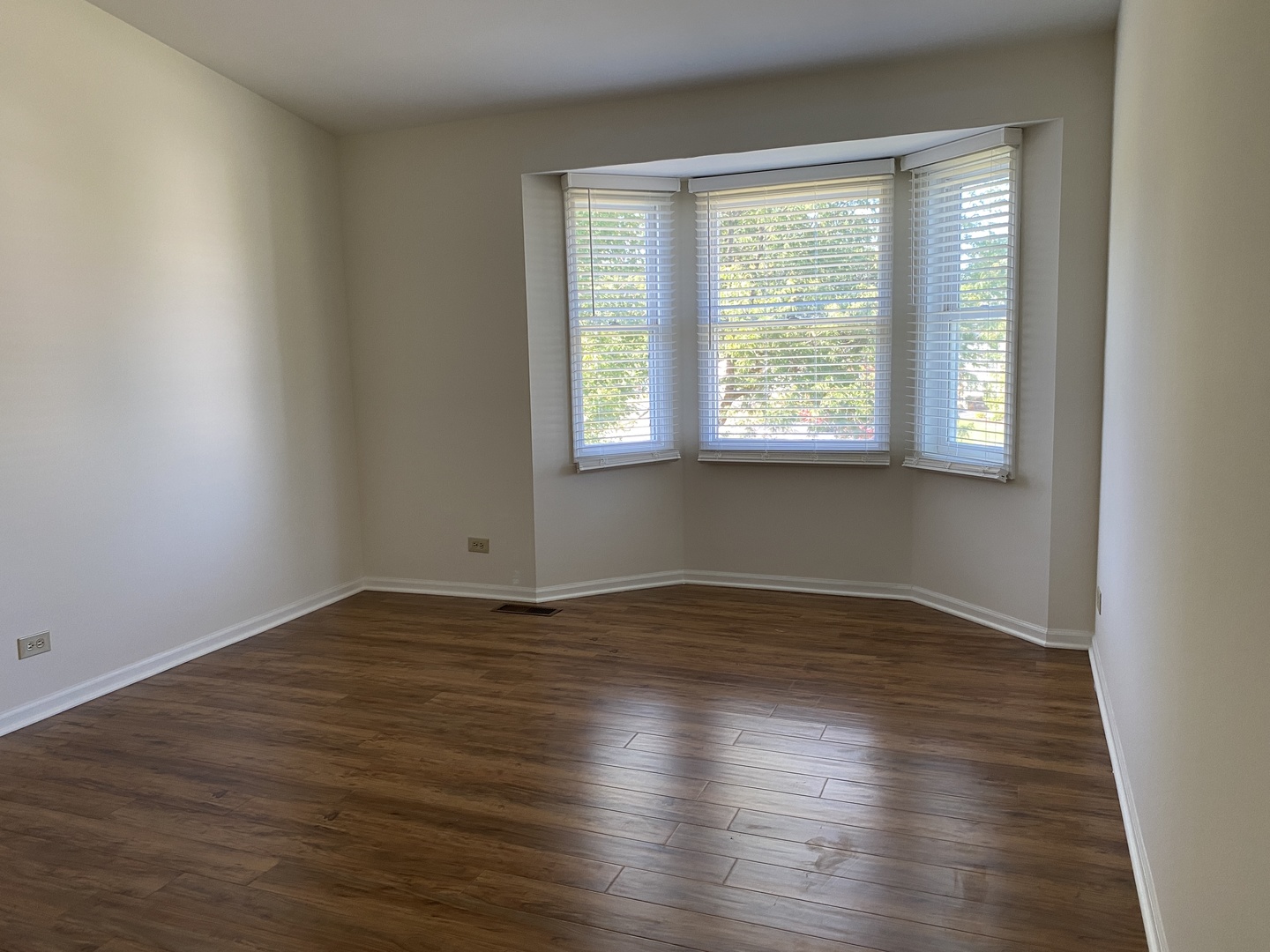720 Daybreak Lane, Unit 720 Carol Stream, IL 60188 - Photo 15 of 22 a view of an empty room with wooden floor and a window