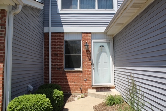 720 Daybreak Lane, Unit 720 Carol Stream, IL 60188 - Photo 2 of 22 a front view of a house with a garden