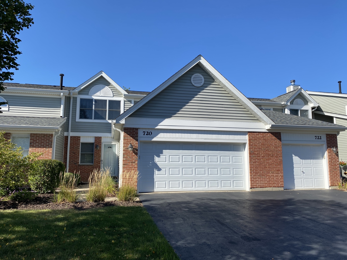 720 Daybreak Lane, Unit 720 Carol Stream, IL 60188 - Photo 21 of 22 a front view of a house with a yard