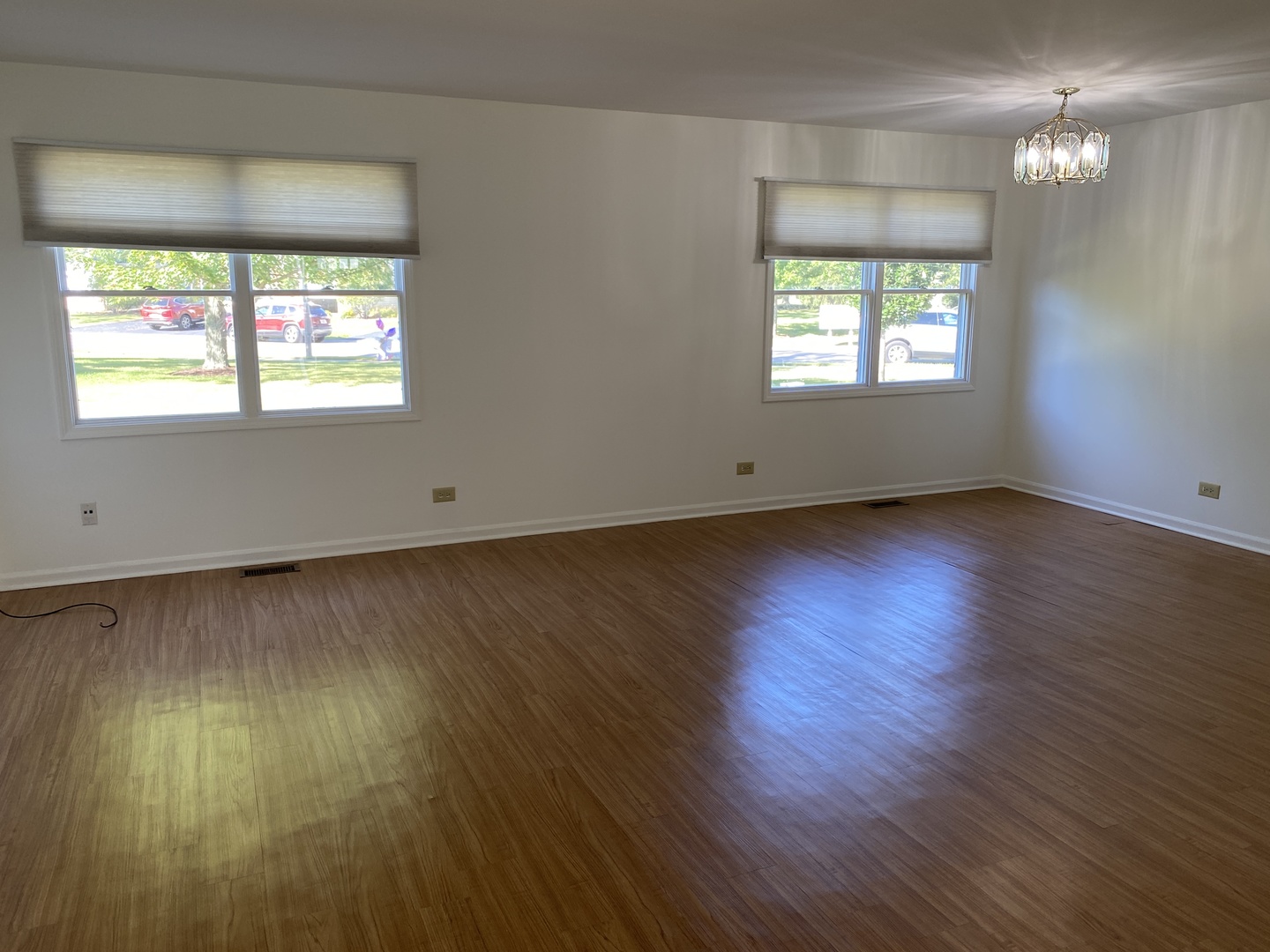 720 Daybreak Lane, Unit 720 Carol Stream, IL 60188 - Photo 3 of 22 an empty room with wooden floor and windows