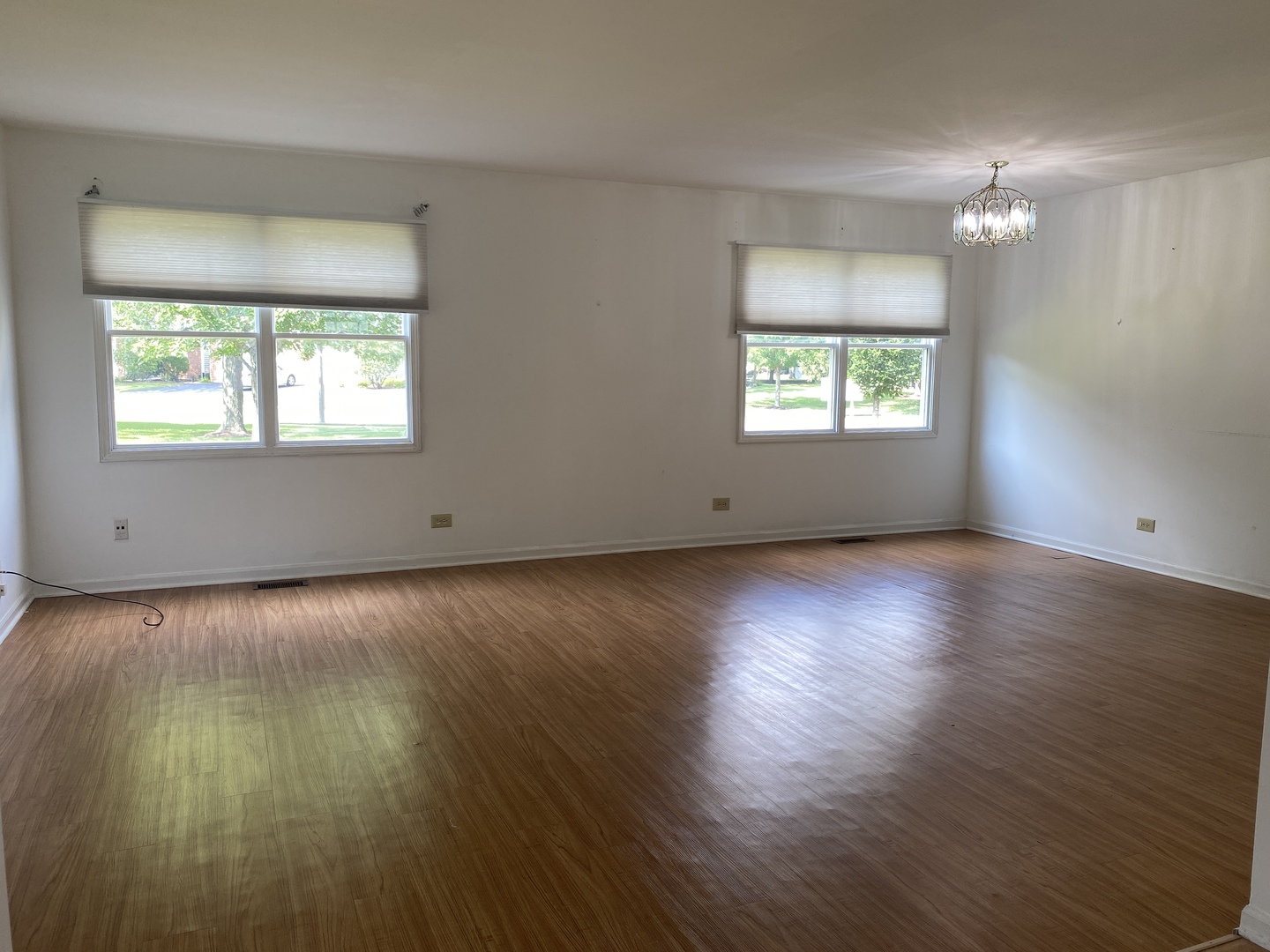 720 Daybreak Lane, Unit 720 Carol Stream, IL 60188 - Photo 4 of 22 an empty room with wooden floor and windows