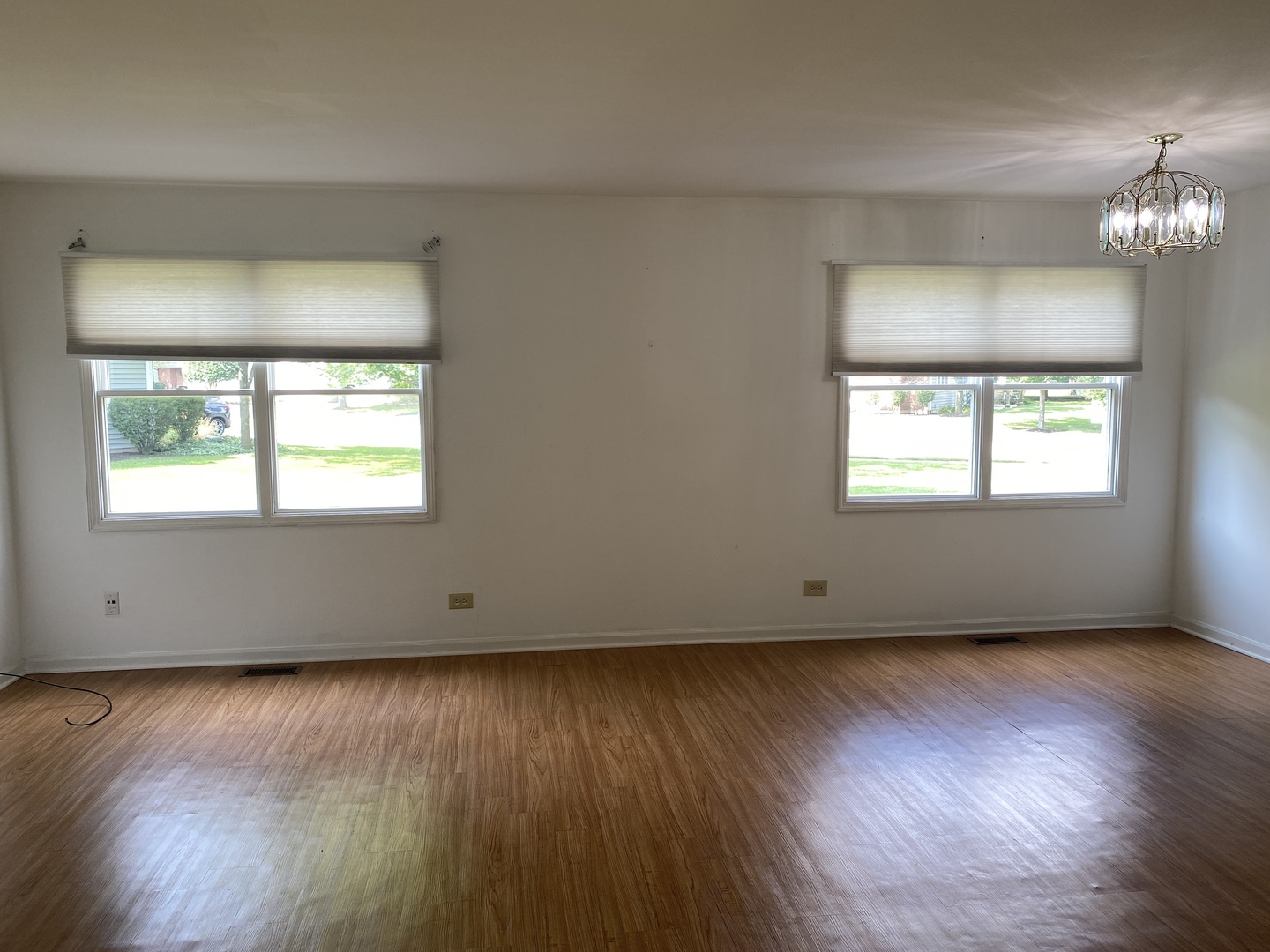 720 Daybreak Lane, Unit 720 Carol Stream, IL 60188 - Photo 5 of 22 a view of an empty room with wooden floor and a window