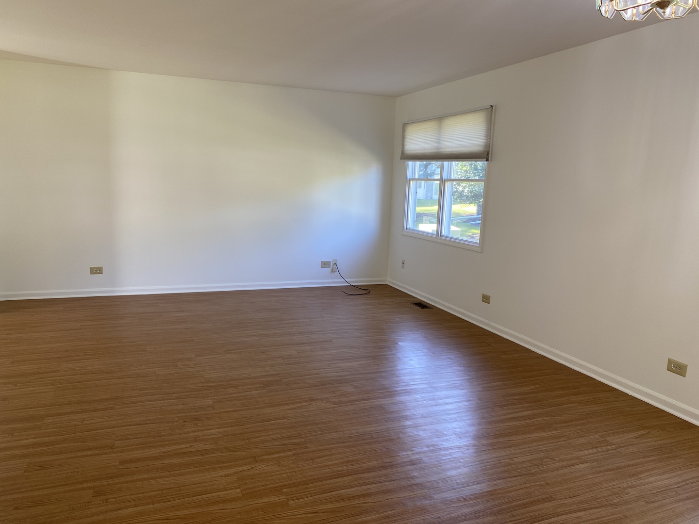 720 Daybreak Lane, Unit 720 Carol Stream, IL 60188 - Photo 6 of 22 an empty room with wooden floor and windows