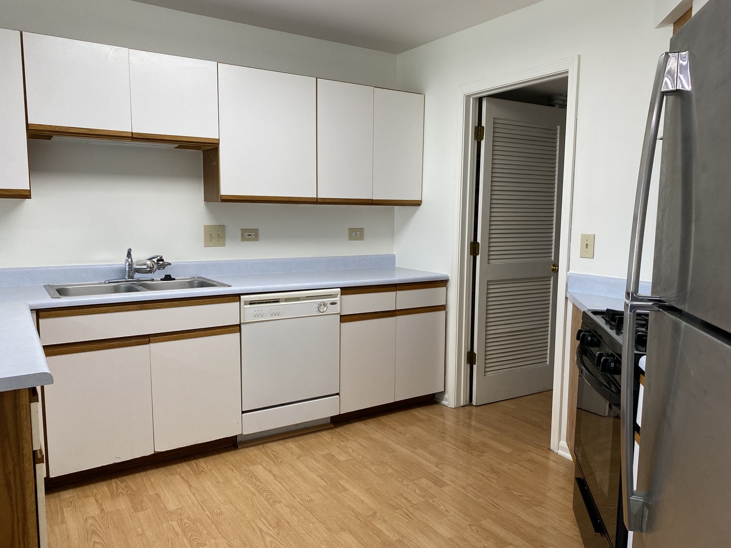 720 Daybreak Lane, Unit 720 Carol Stream, IL 60188 - Photo 7 of 22 a kitchen with stainless steel appliances white cabinets and a refrigerator