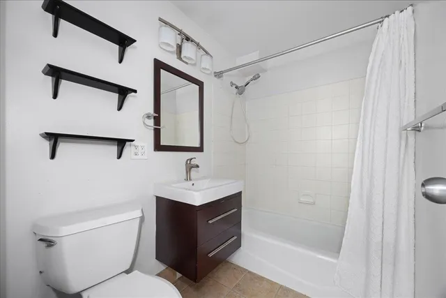 a bathroom with a toilet sink and shower