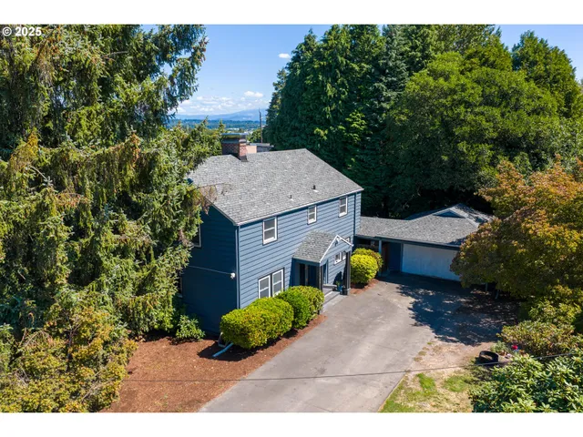 a view of an house with chairs and yard