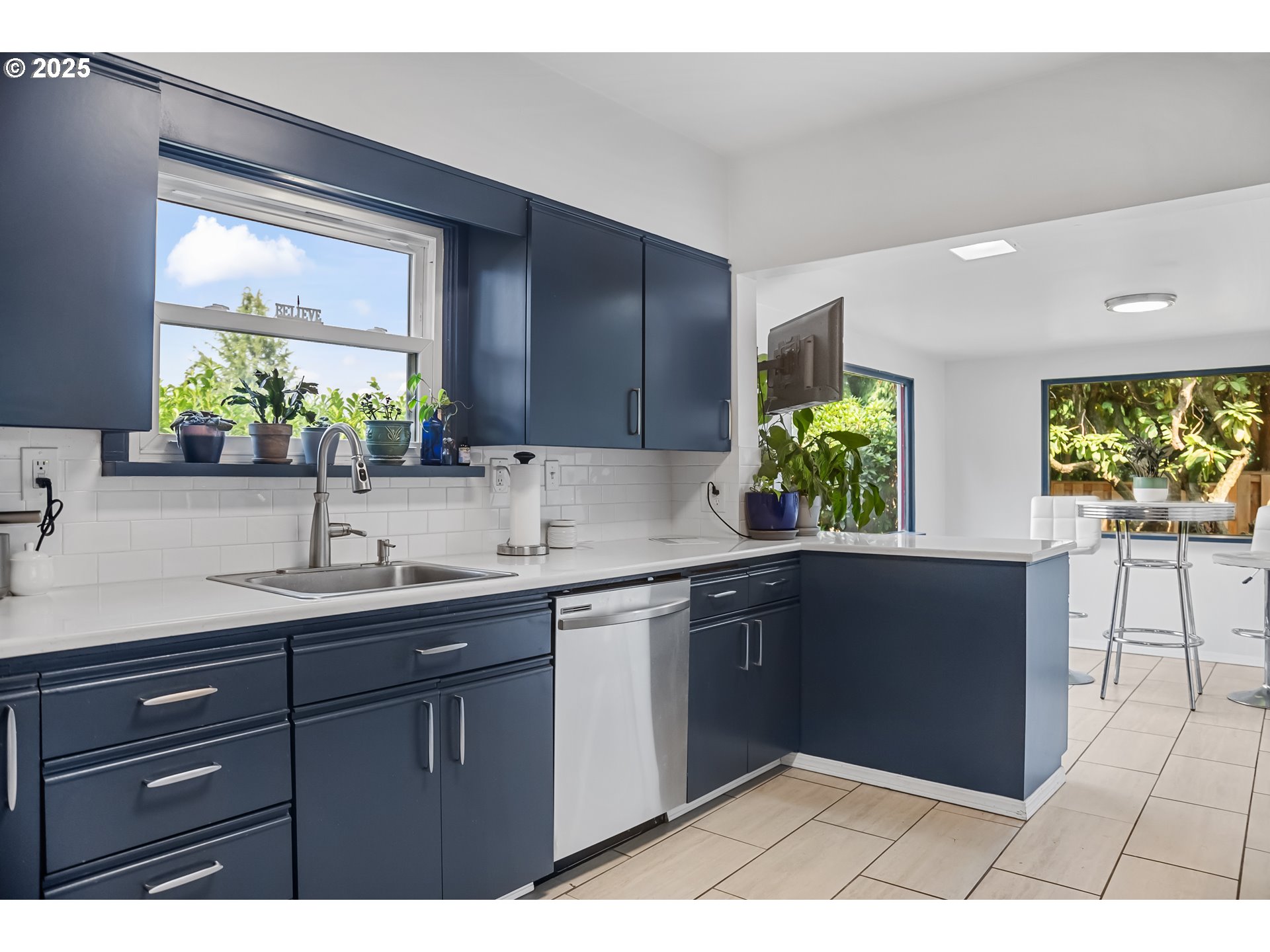 6026 Northeast 57th Avenue Portland, OR 97218 - Photo 12 of 45 a kitchen with a sink and cabinets