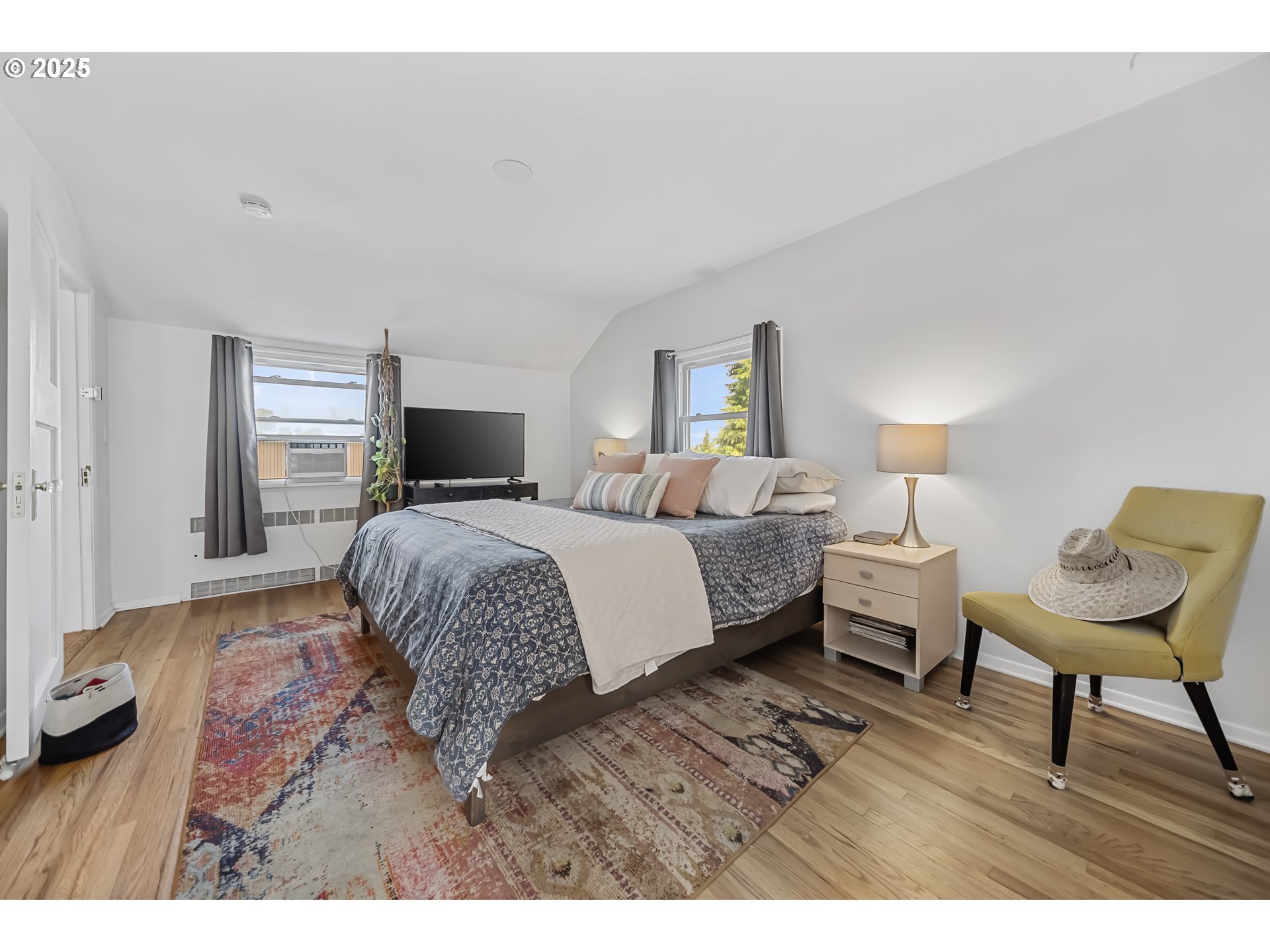 6026 Northeast 57th Avenue Portland, OR 97218 - Photo 15 of 45 a bedroom with a bed and a chair