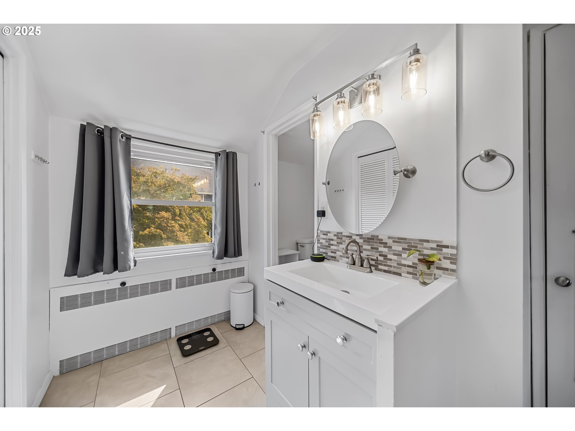 6026 Northeast 57th Avenue Portland, OR 97218 - Photo 18 of 45 a bathroom with a sink vanity and a mirror