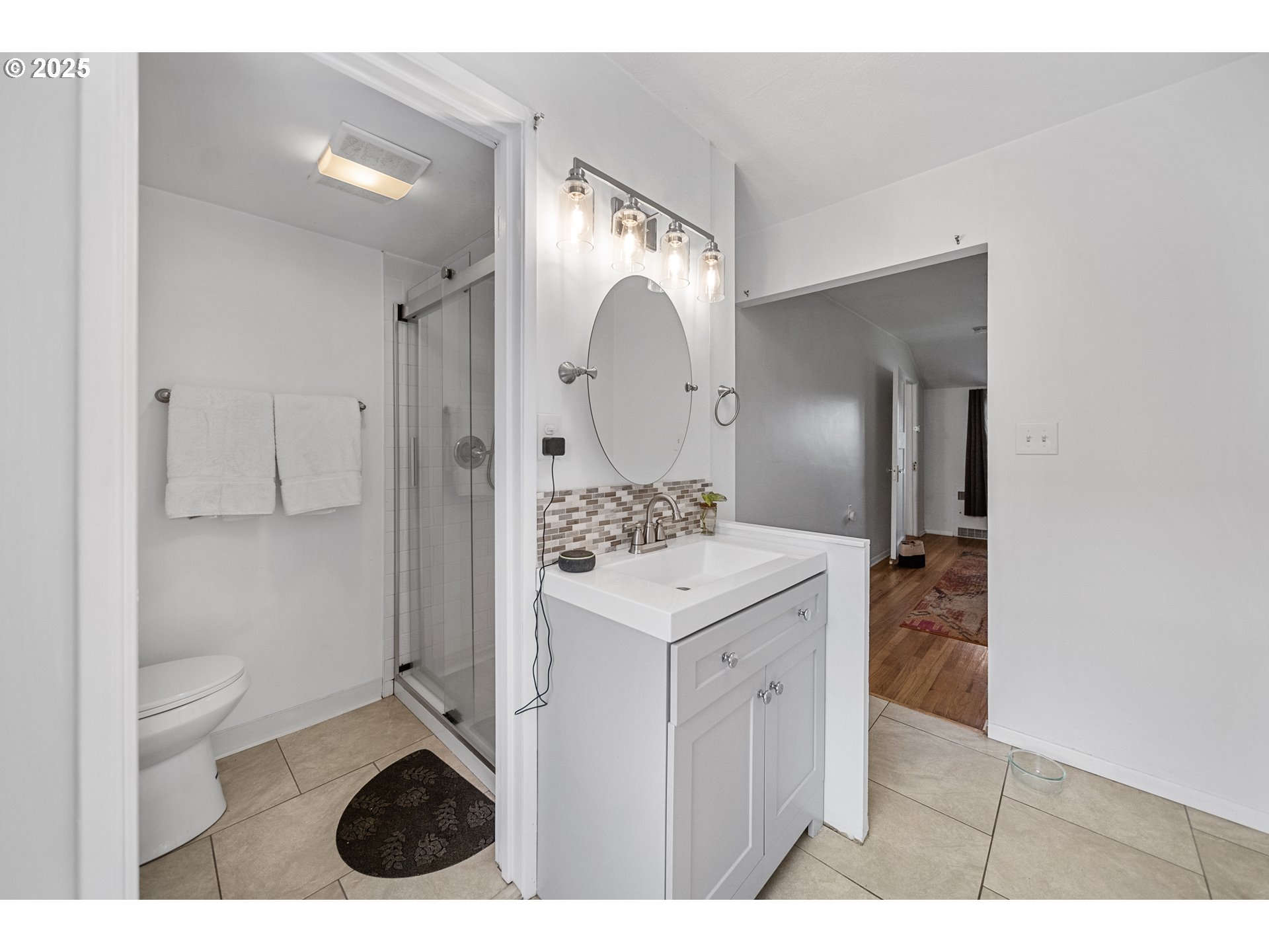 6026 Northeast 57th Avenue Portland, OR 97218 - Photo 19 of 45 a bathroom with a sink a toilet and shower