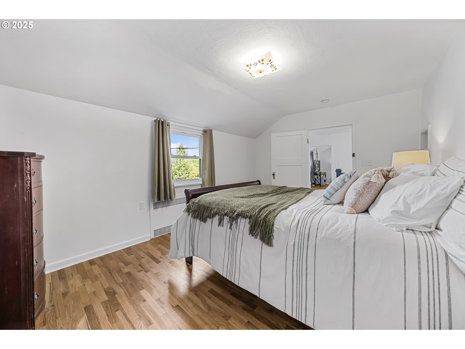 6026 Northeast 57th Avenue Portland, OR 97218 - Photo 23 of 45 a bedroom with a bed and a night stand