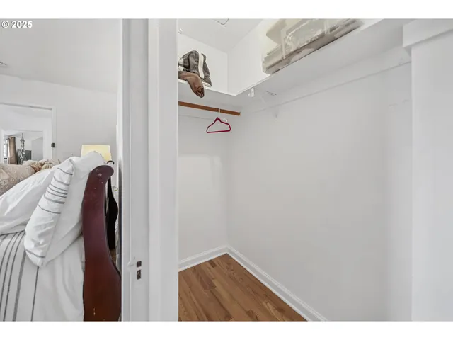 a view of walk in closet with clothes and shoes