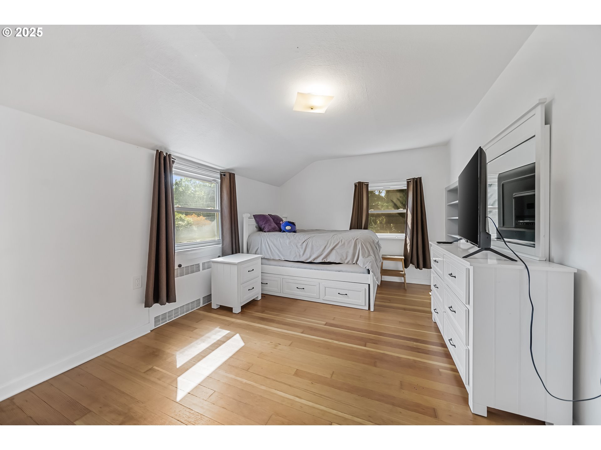 6026 Northeast 57th Avenue Portland, OR 97218 - Photo 27 of 45 a living room with furniture and a flat screen tv