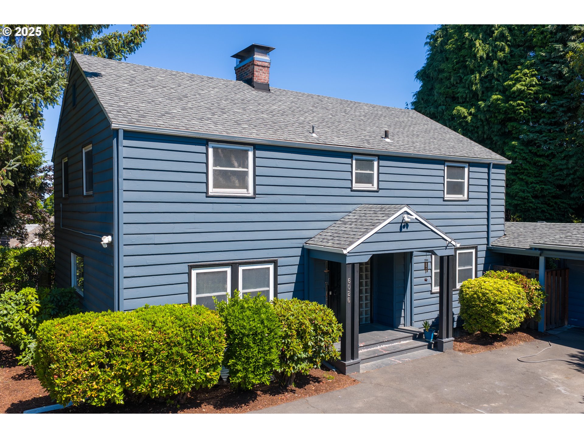 6026 Northeast 57th Avenue Portland, OR 97218 - Photo 3 of 45 a front view of a house with garden