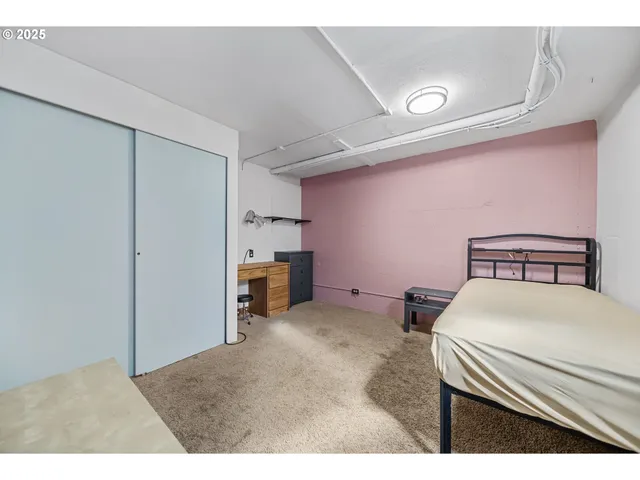 a bedroom with furniture and a flat screen tv