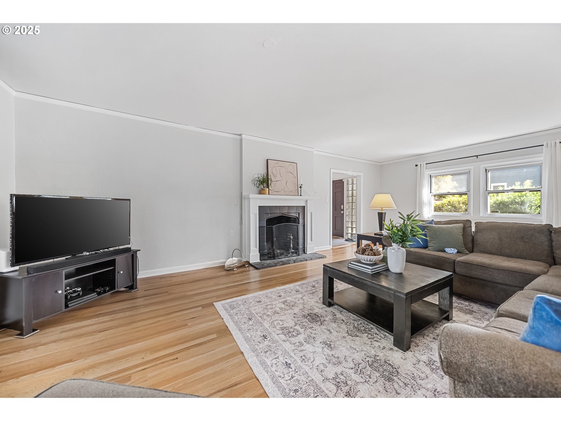 6026 Northeast 57th Avenue Portland, OR 97218 - Photo 5 of 45 a living room with furniture flat screen tv and a fireplace