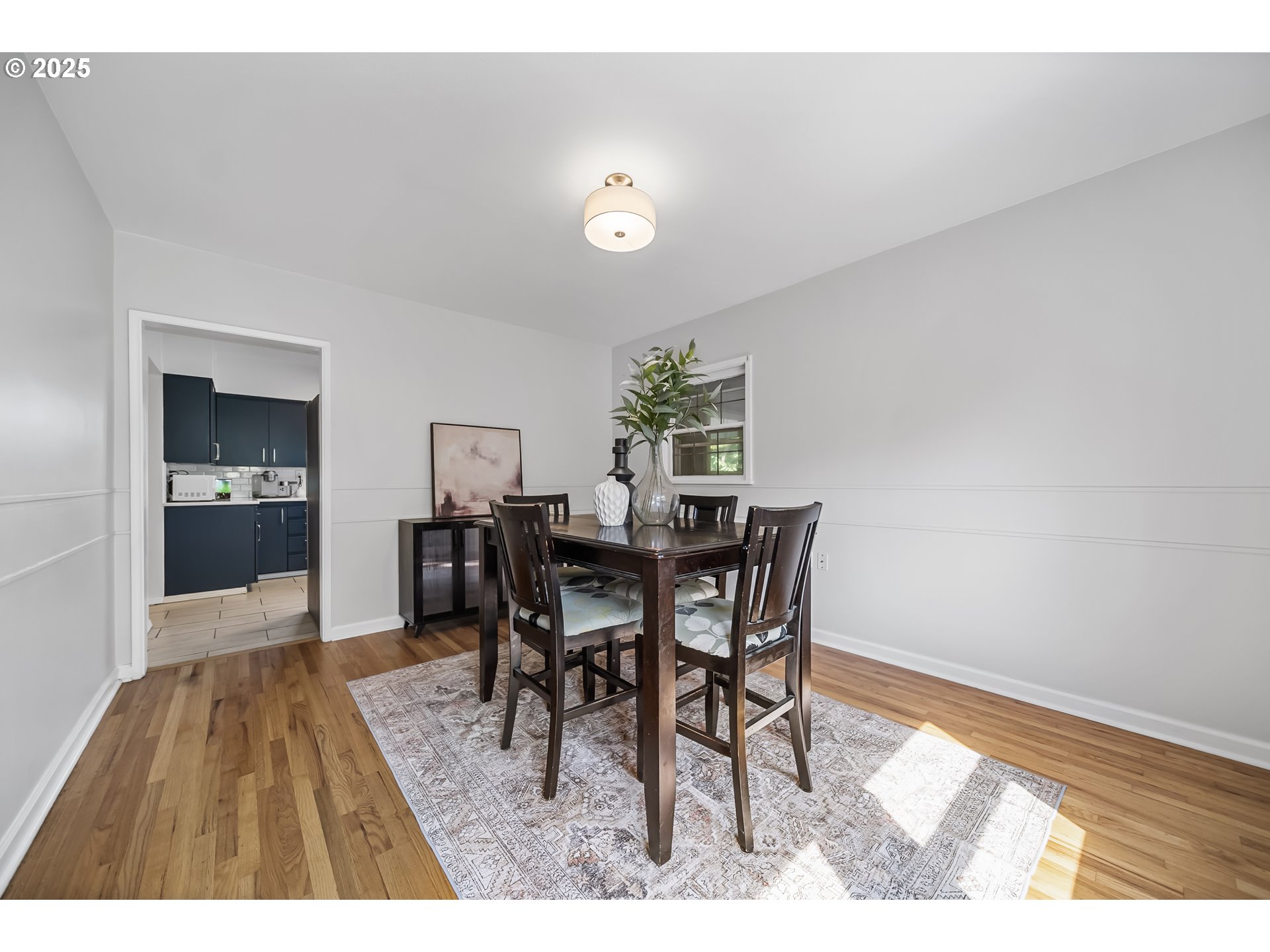 6026 Northeast 57th Avenue Portland, OR 97218 - Photo 7 of 45 a view of a dining room with furniture and wooden floor