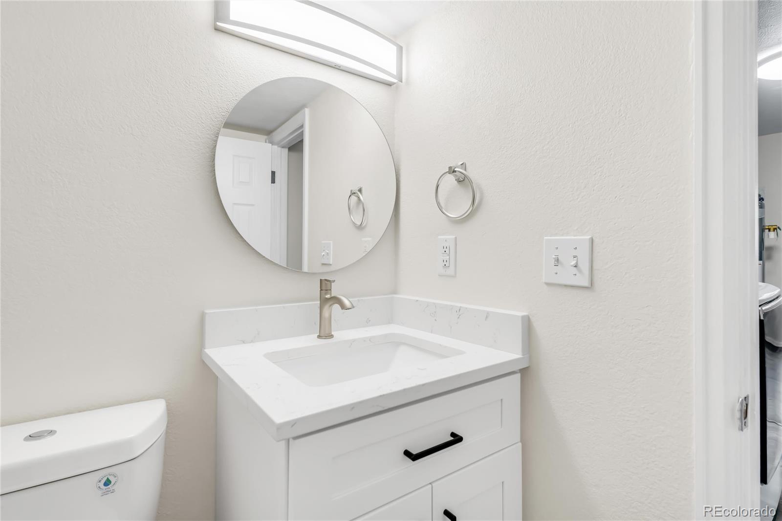 9215 Lowell Boulevard Westminster, CO 80031 - Photo 15 of 30 a bathroom with a sink and a mirror