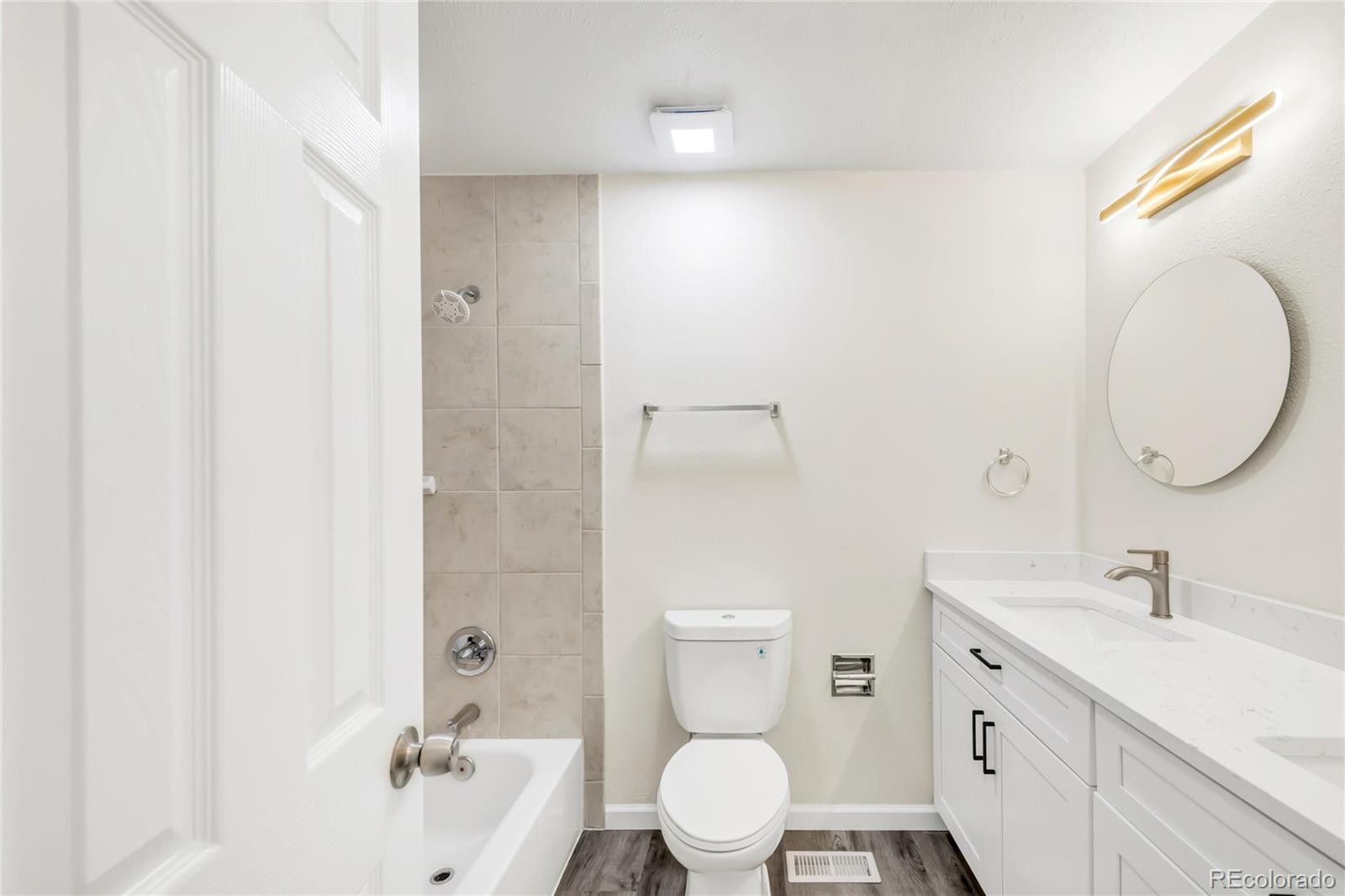9215 Lowell Boulevard Westminster, CO 80031 - Photo 19 of 30 a bathroom with a sink a toilet and shower