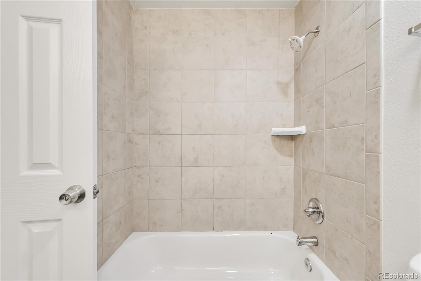 9215 Lowell Boulevard Westminster, CO 80031 - Photo 20 of 30 a bathroom with a shower and a bath tub