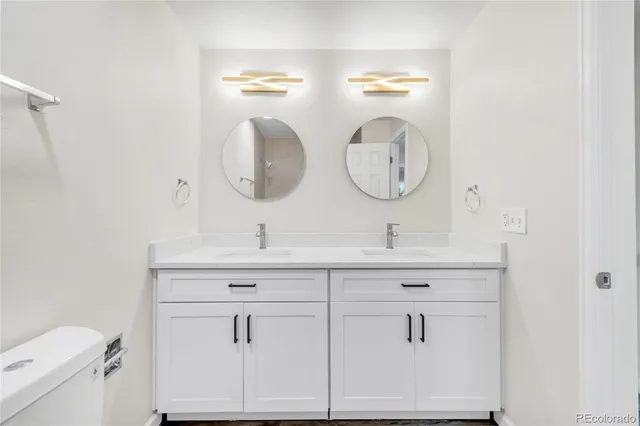 a bathroom with a double vanity sink and a mirror