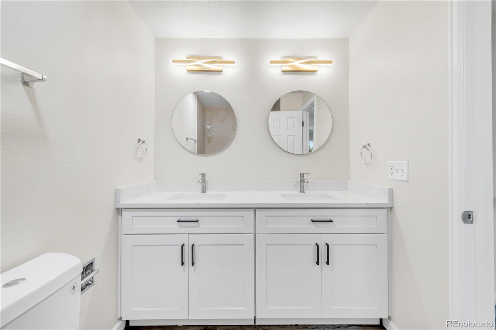 9215 Lowell Boulevard Westminster, CO 80031 - Photo 21 of 30 a bathroom with a double vanity sink and a mirror