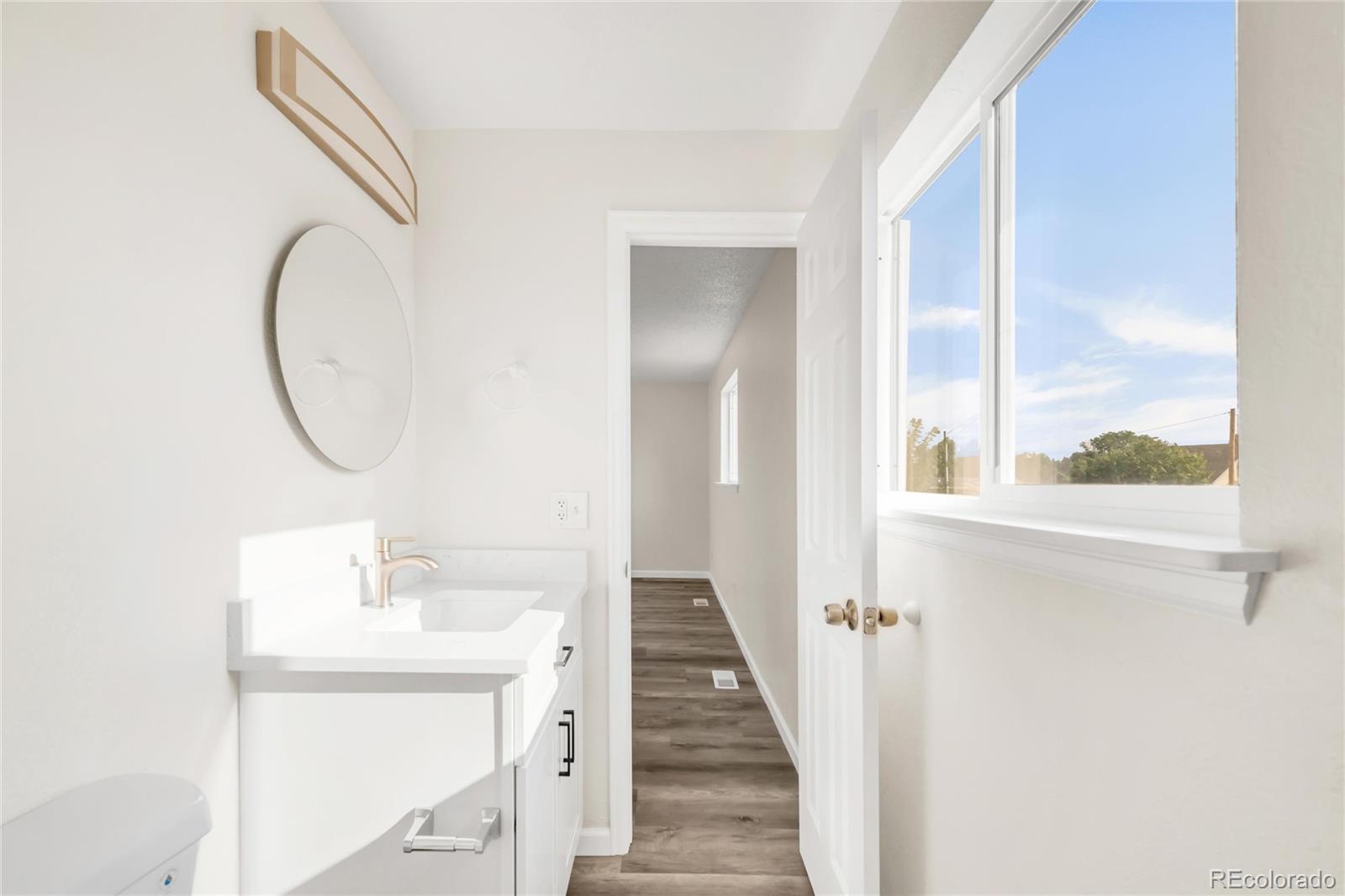 9215 Lowell Boulevard Westminster, CO 80031 - Photo 27 of 30 a bathroom with a sink mirror and a window
