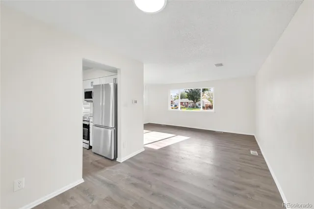 an empty room with windows and closet