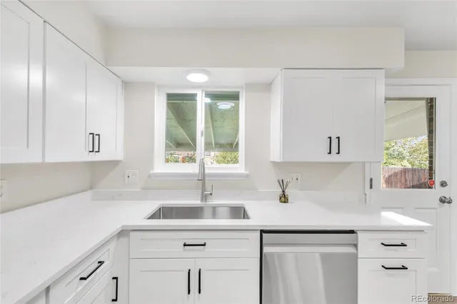 a kitchen with a sink cabinets and window