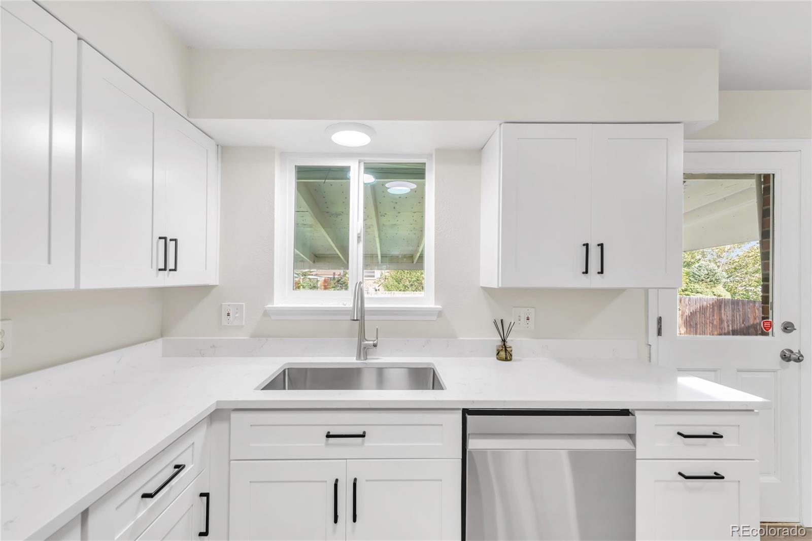 9215 Lowell Boulevard Westminster, CO 80031 - Photo 8 of 30 a kitchen with a sink cabinets and window