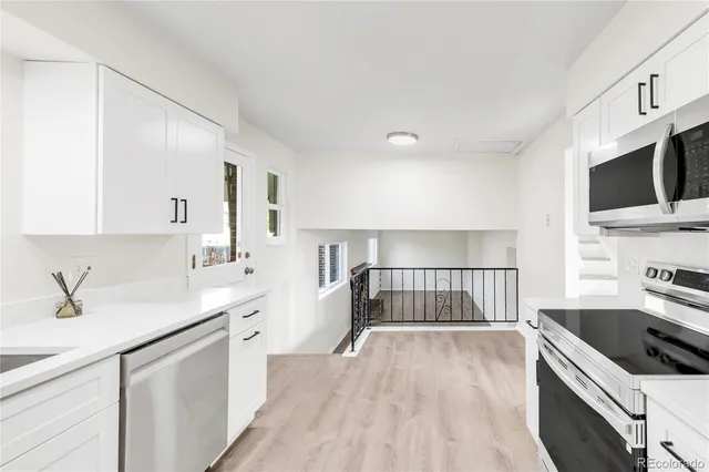 a kitchen with a sink stove and microwave