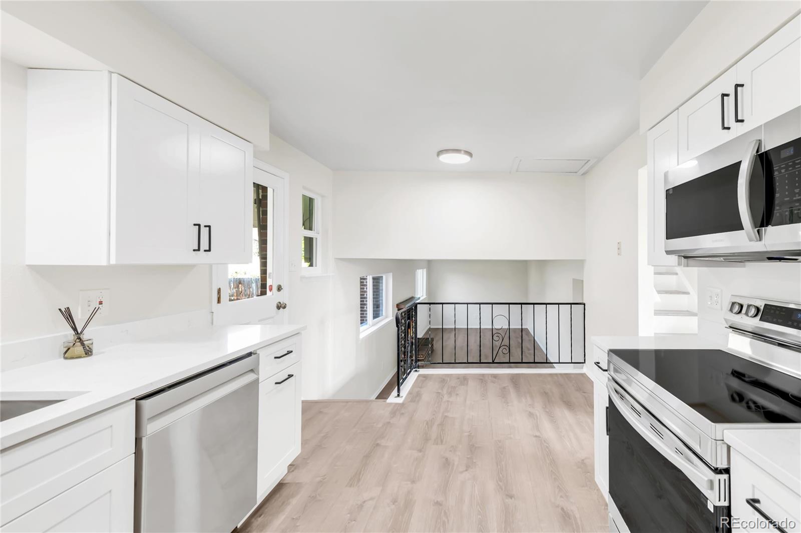 9215 Lowell Boulevard Westminster, CO 80031 - Photo 10 of 30 a kitchen with a sink stove and microwave