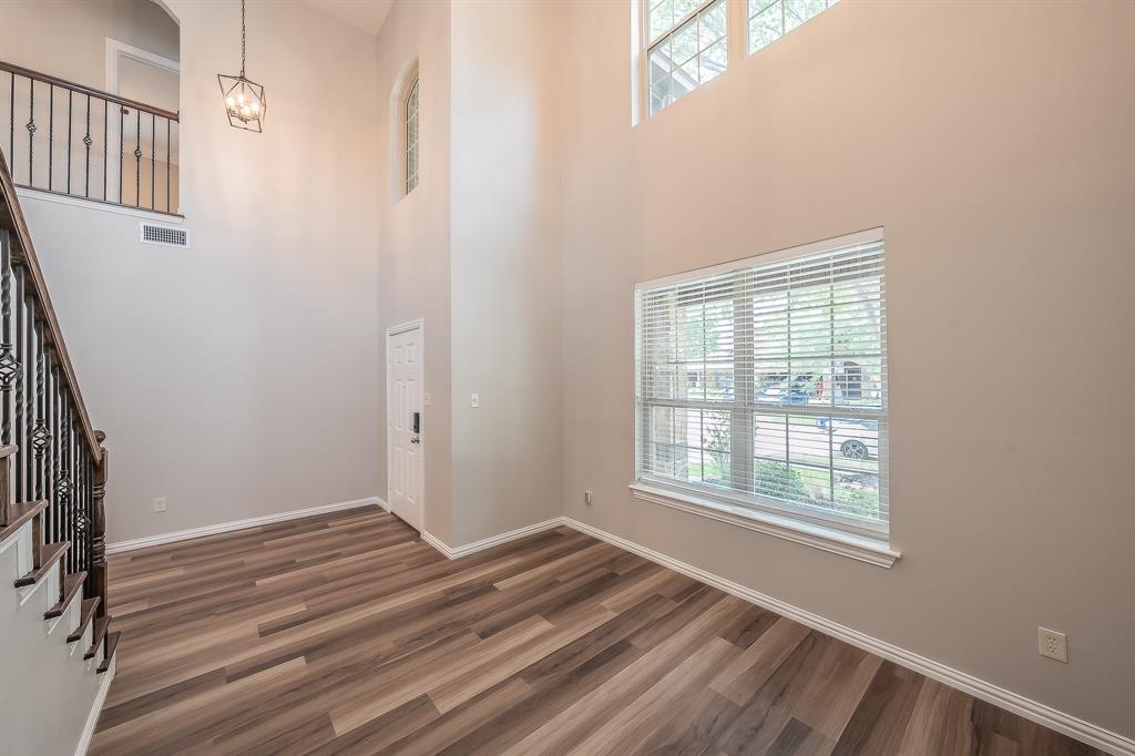412 Hideaway Road McKinney, TX 75072 - Photo 6 of 40 an empty room with wooden floor and windows
