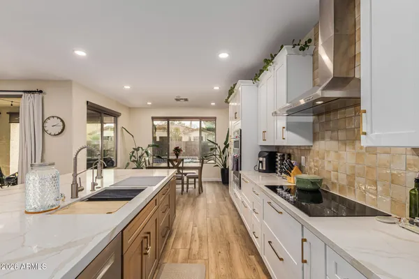 a large kitchen with stainless steel appliances lots of counter space and a sink