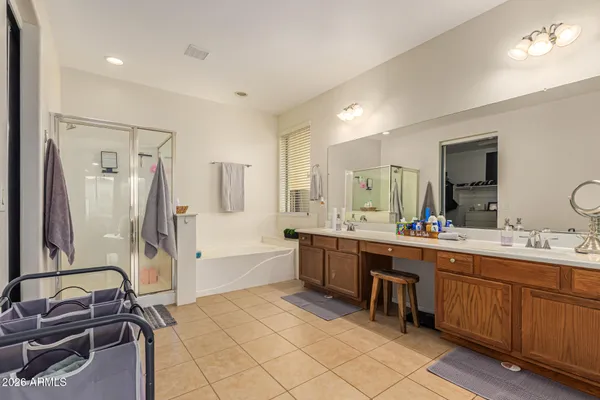 a room with a sink and a large mirror