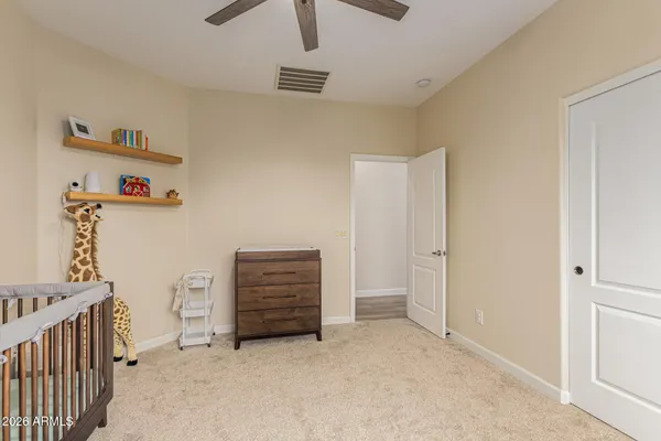 a view of room with baby crib and stairs